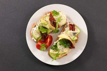 bread slice with zucchini, cheese cream and tomato