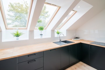 Bright kitchen with slanted ceiling. - obrazy, fototapety, plakaty