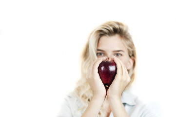 Very beautiful young bright girl holding a red apple in her hands on a white background