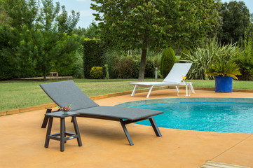 Sun lounger near pool.