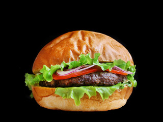 burger isolated on black. burger with salad tomatoes onion and pikles