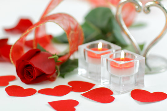 background image of two candles and a beautiful rose on a white background