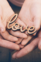 hands holding word love
