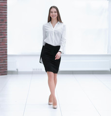 Beautiful confident businesswoman walking through a corridor