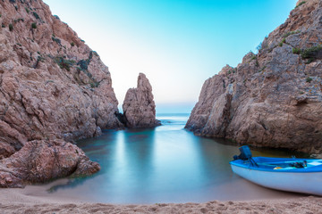 Waves hitting shore, rocks and cliffs in Tossa De Mar beach,
