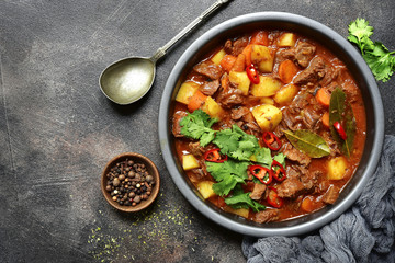 Meat stewed with vegetables in tomato sauce (hungarian goulash) .Top view with copy space.