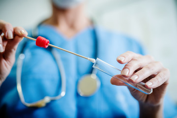 Close up of doctor with sample from sick woman. Selective focus on sample..