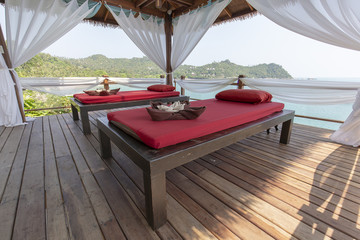 Massage table overlooking the sea. Spa massage room on the beach in Thailand