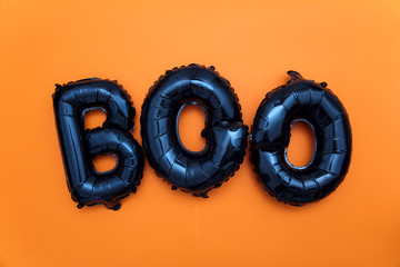Halloween balloon word boo on an orange background