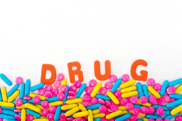 The word letters DRUGS and various medication and pills