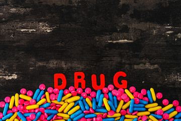 The word letters DRUGS and various medication and pills