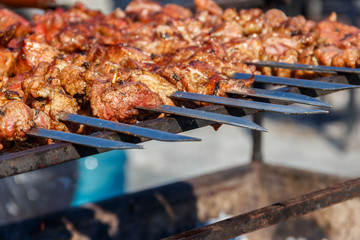 Grilled kebab cooking on metal skewer. Roasted meat cooked at barbecue