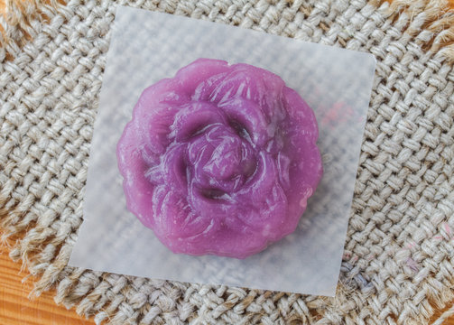 Snow Lotus cake on sack, stensil paper, wooden table,