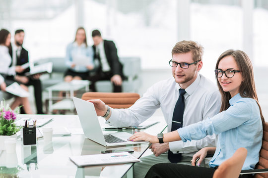 sales Manager and accountant are working on a laptop with financ