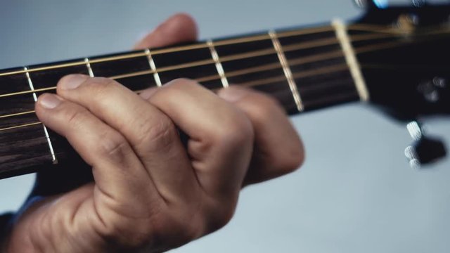 Man playing acoustic guitar on white background