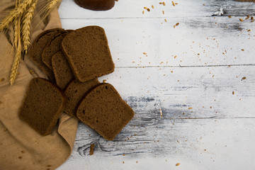 White wheat rye sliced tasty and delicious bread on wooden background