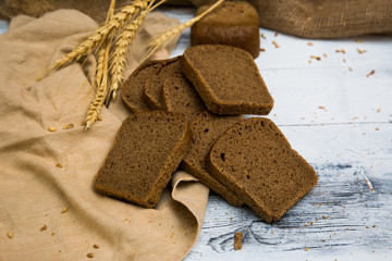 White wheat rye sliced tasty and delicious bread on wooden background