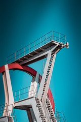 Rome, Italy, Oct 6th 2018, old red and white abandoned diving structure, in local public pool, will soon be demolished. Local building laws have finalized the new sports and recreation center project.