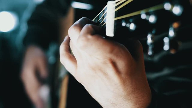 Man playing the guitar,practicing in playing guitar, handsome young men playing guitar, man playing the guitar