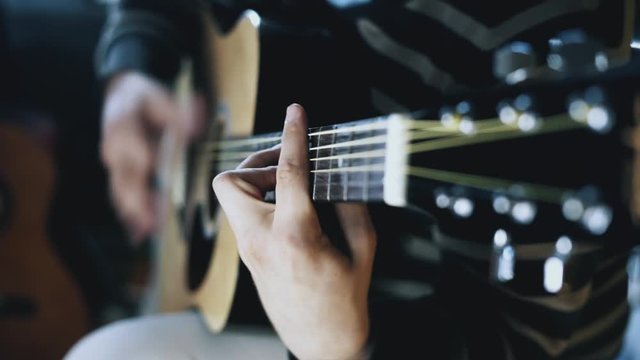 Man playing the guitar, practicing in playing guitar