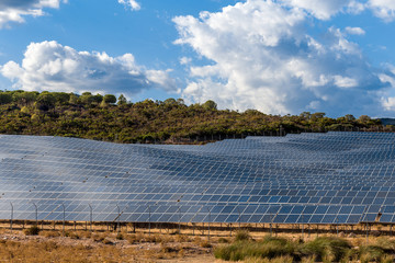 a river of solar panels in the middle of the hills
