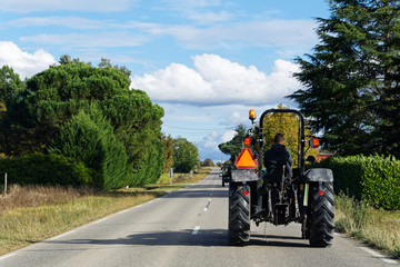 Naklejka premium Tracteur sur route de campagne