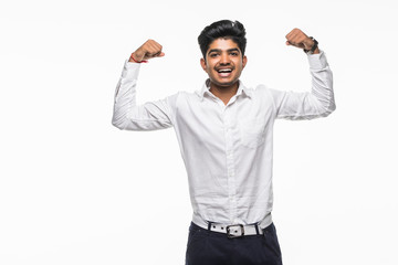 Fototapeta premium Adult indian business man over isolated white background showing arms muscles smiling proud.