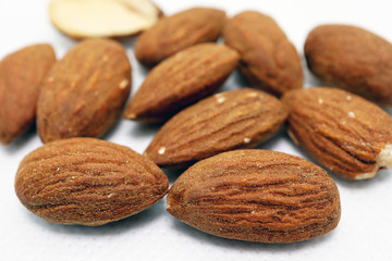 Macro photo of Almonds baked crispness on white background, Snack foods or healthy concept.