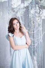 Fototapeta premium Beautiful young woman in silver studio