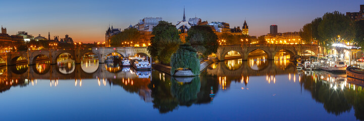 Panoramic view of Ile de la Cite and Pont Neuf at sunrise in Paris, France, as seen from Pont des...
