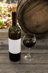 Red wine bottle on a wooden background