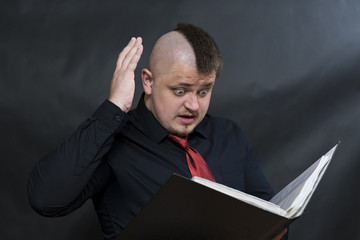 Punk stands with a working folder. One hand is raised above the head. Facial expression anger and...
