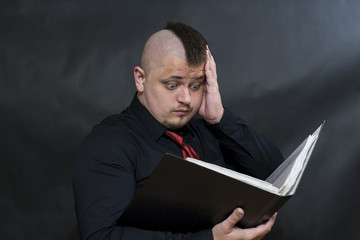 Punk stands with a working folder. One hand is raised to the head. On the face of surprise and...