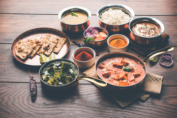 Indian Lunch / Dinner main course food in group includes Paneer Butter Masala, Dal Makhani, Palak Paneer, Roti, Rice etc, Selective focus