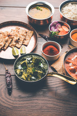 Indian Lunch / Dinner main course food in group includes Paneer Butter Masala, Dal Makhani, Palak Paneer, Roti, Rice etc, Selective focus