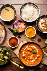 Indian Lunch / Dinner main course food in group includes Paneer Butter Masala, Dal Makhani, Palak Paneer, Roti, Rice etc, Selective focus