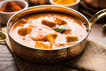 Paneer Butter Masala or Cheese Cottage Curry in serving a bowl or pan, served with or without roti and rice