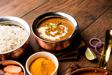 Dal makhani / makhni is a popular dish from India. Made with ingredients like whole black lentil, butter and cream. Served with Naan/roti and rice