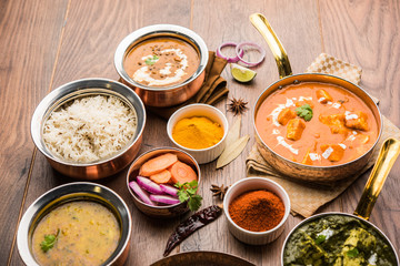 Indian Lunch / Dinner main course food in group includes Paneer Butter Masala, Dal Makhani, Palak Paneer, Roti, Rice etc, Selective focus