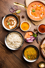 Indian Lunch / Dinner main course food in group includes Paneer Butter Masala, Dal Makhani, Palak Paneer, Roti, Rice etc, Selective focus