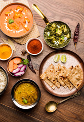 Indian Lunch / Dinner main course food in group includes Paneer Butter Masala, Dal Makhani, Palak Paneer, Roti, Rice etc, Selective focus