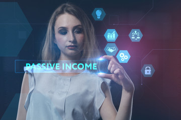 The concept of business, technology, the Internet and the network. A young entrepreneur working on a virtual screen of the future and sees the inscription: Passive income