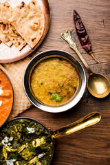 Dal Tadka Fry / Indian Lentil Curry served in a bowl with rice and roti, selective focus