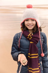 Girl with ammonite fossil in hand
