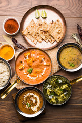 Indian Lunch / Dinner main course food in group includes Paneer Butter Masala, Dal Makhani, Palak Paneer, Roti, Rice etc, Selective focus