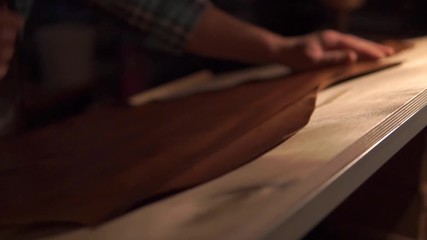 ancient workshop with expert shoemaker during the processing of leather to produce shoes with vintage effect