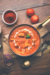 Paneer Butter Masala or Cheese Cottage Curry in serving a bowl or pan, served with or without roti and rice