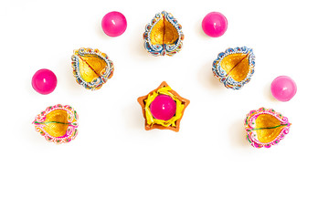 Happy Diwali - Clay Diya lamps lit during Dipavali, Hindu festival of lights celebration. Colorful traditional oil lamp diya on white background