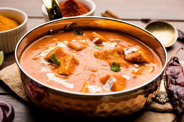 Paneer Butter Masala or Cheese Cottage Curry in serving a bowl or pan, served with or without roti and rice