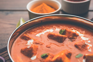 Paneer Butter Masala or Cheese Cottage Curry in serving a bowl or pan, served with or without roti and rice